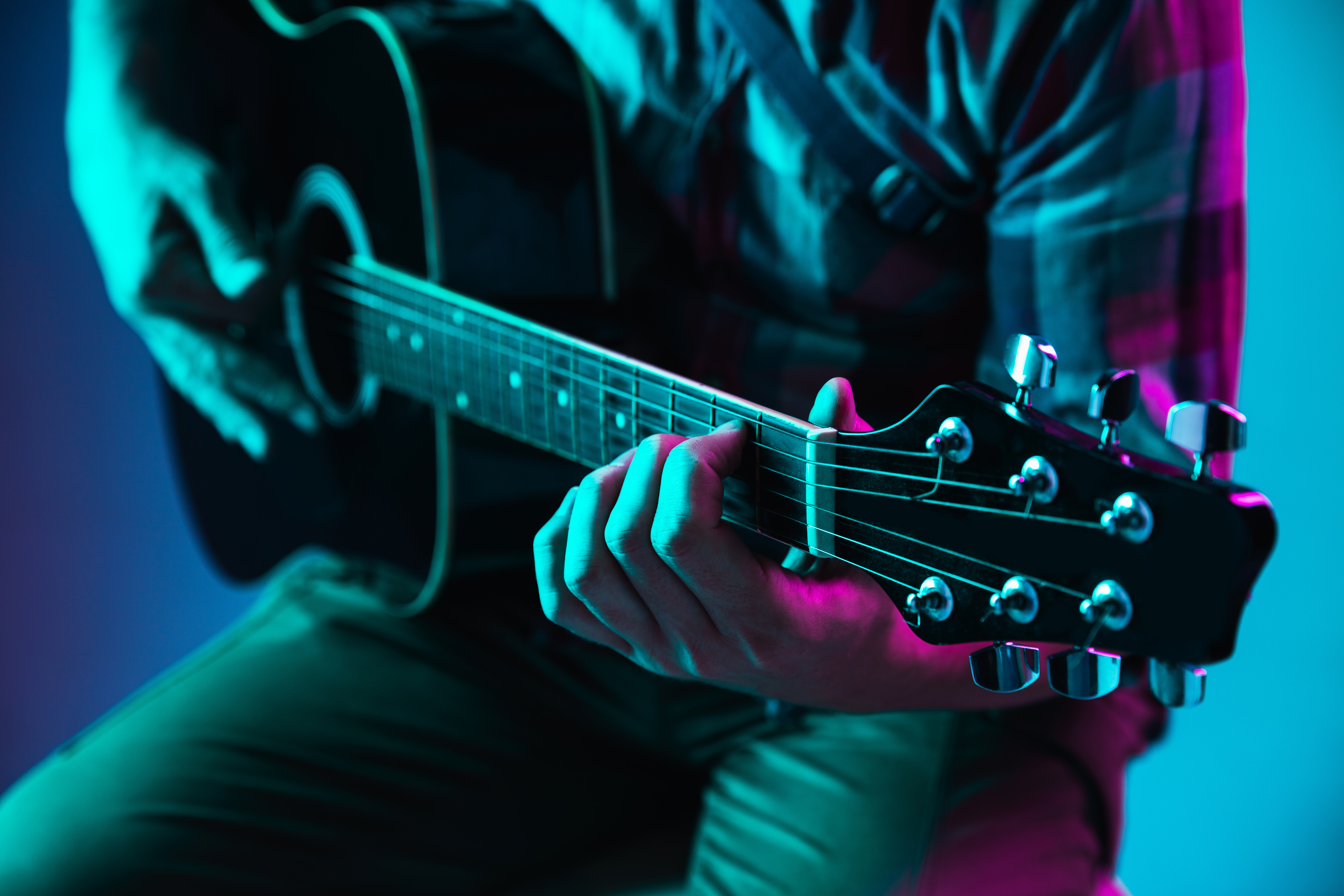 close-up-guitarist-hand-playing-guitar-macro-concept-advertising-hobby-music-festival-entertainment-person-improvising-inspired-copyspace-insert-image-text-colorful-neon-lighted